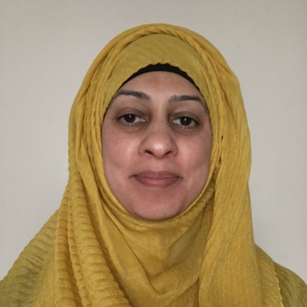 Tayyaba is smiling, wearing a yellow hijab (scarf on her head).