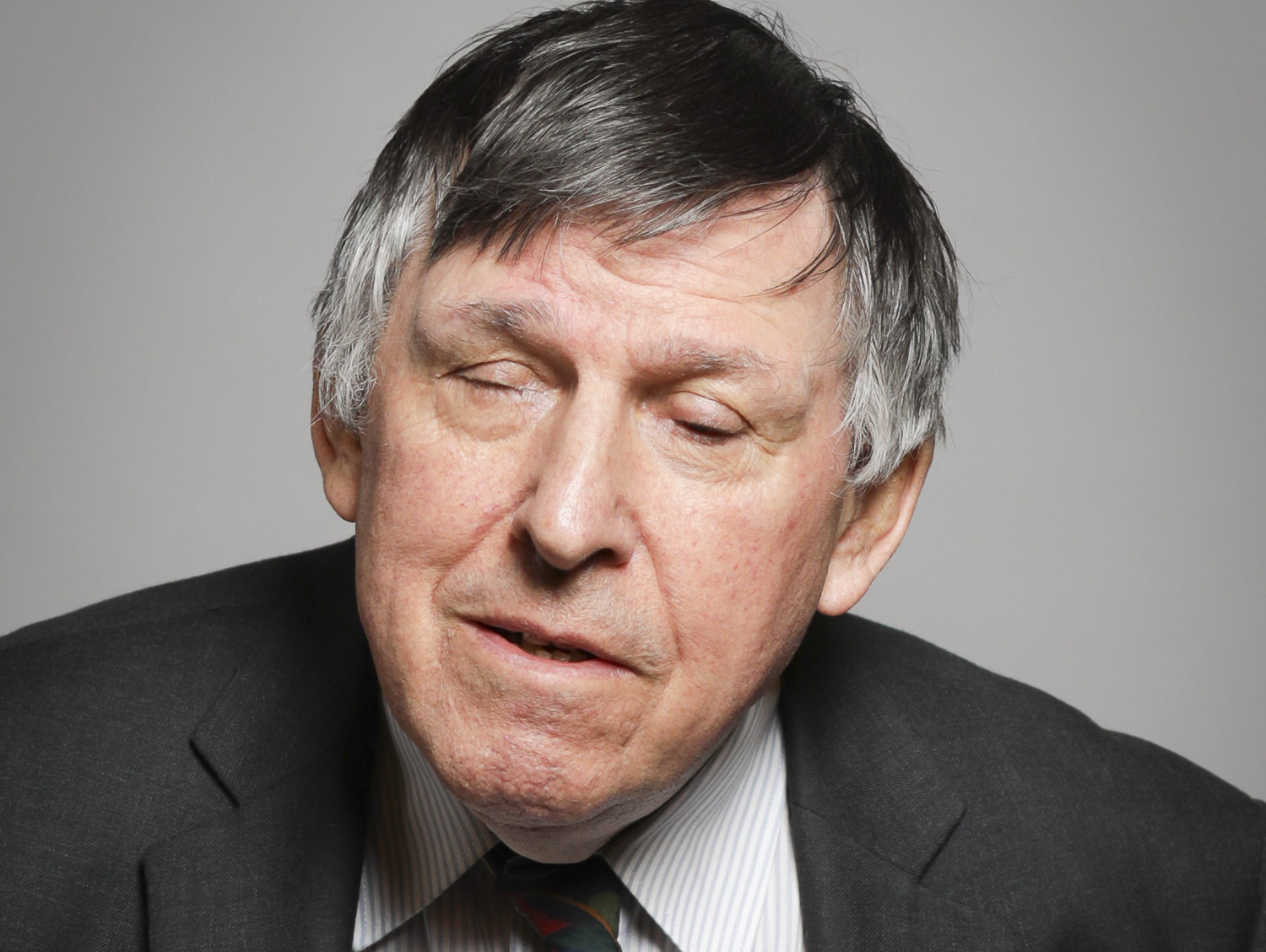 Lord Colin Low, CBE Image is a photo of Lord Low, half smiling at the camera