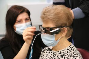 image is a photo of a lady wearing a face mask, during her procedure