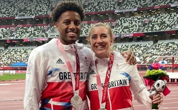 Photo of Paralymic Champions Libby Clegg (left) and Chris Clarke (right) in sports outfits, wearing their medals.