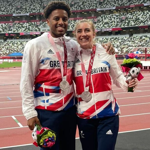 Photo of Paralymic Champions Libby Clegg (left) and Chris Clarke (right) in sports outfits, wearing their medals.