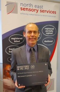 Graham Findlay, Chief Executive of NESS holding IIP plaque.
