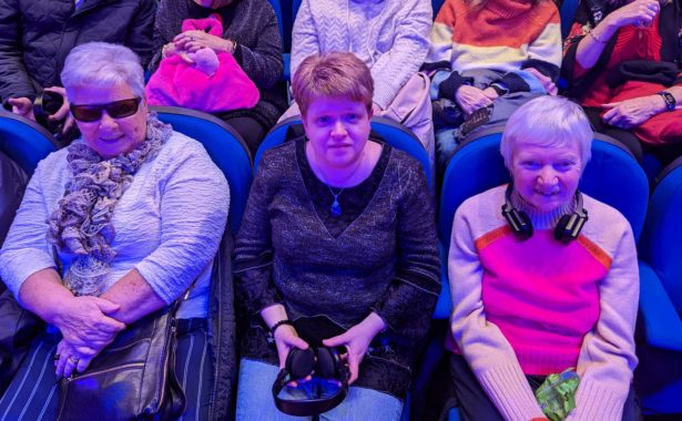 Eleanor, Joanne and Christine sitting in the audience for the accessible pantomime.