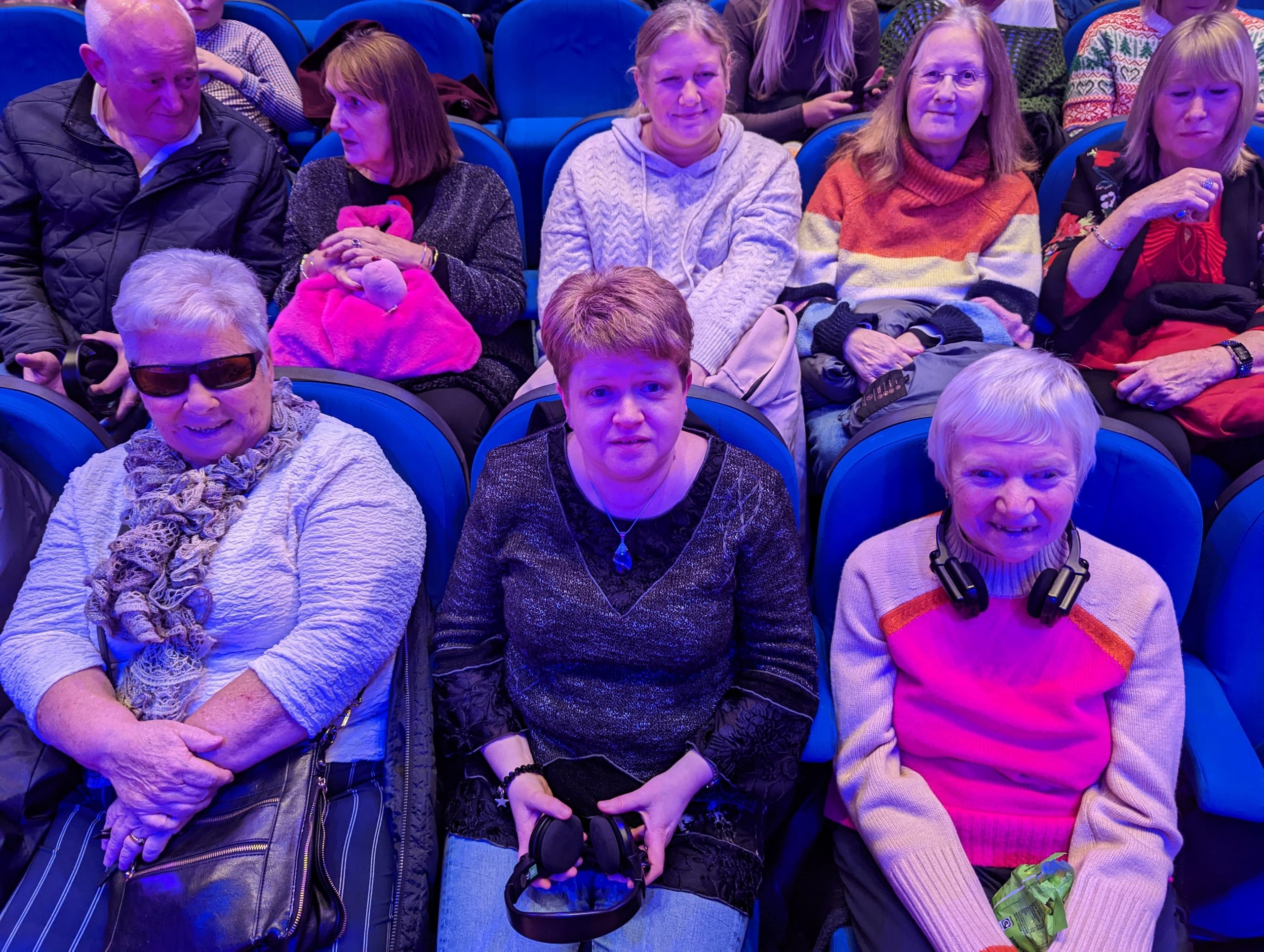 Eleanor, Joanne and Christine sitting in the audience for the accessible pantomime.