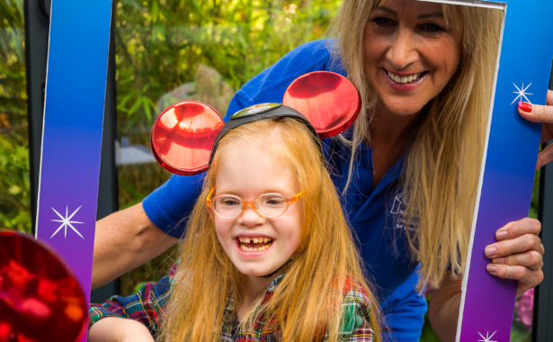 Penny Dane and Hope, age 6, in the centre of a large Disney on Ice photo frame