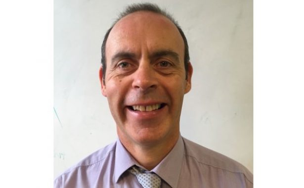 Graham Findlay smiling, wearing shirt and tie.