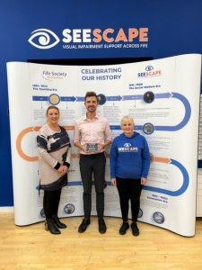Donna, Steve and Caroline from Seescape proudly standing together, Steve is holding the award in the centre of the picture.