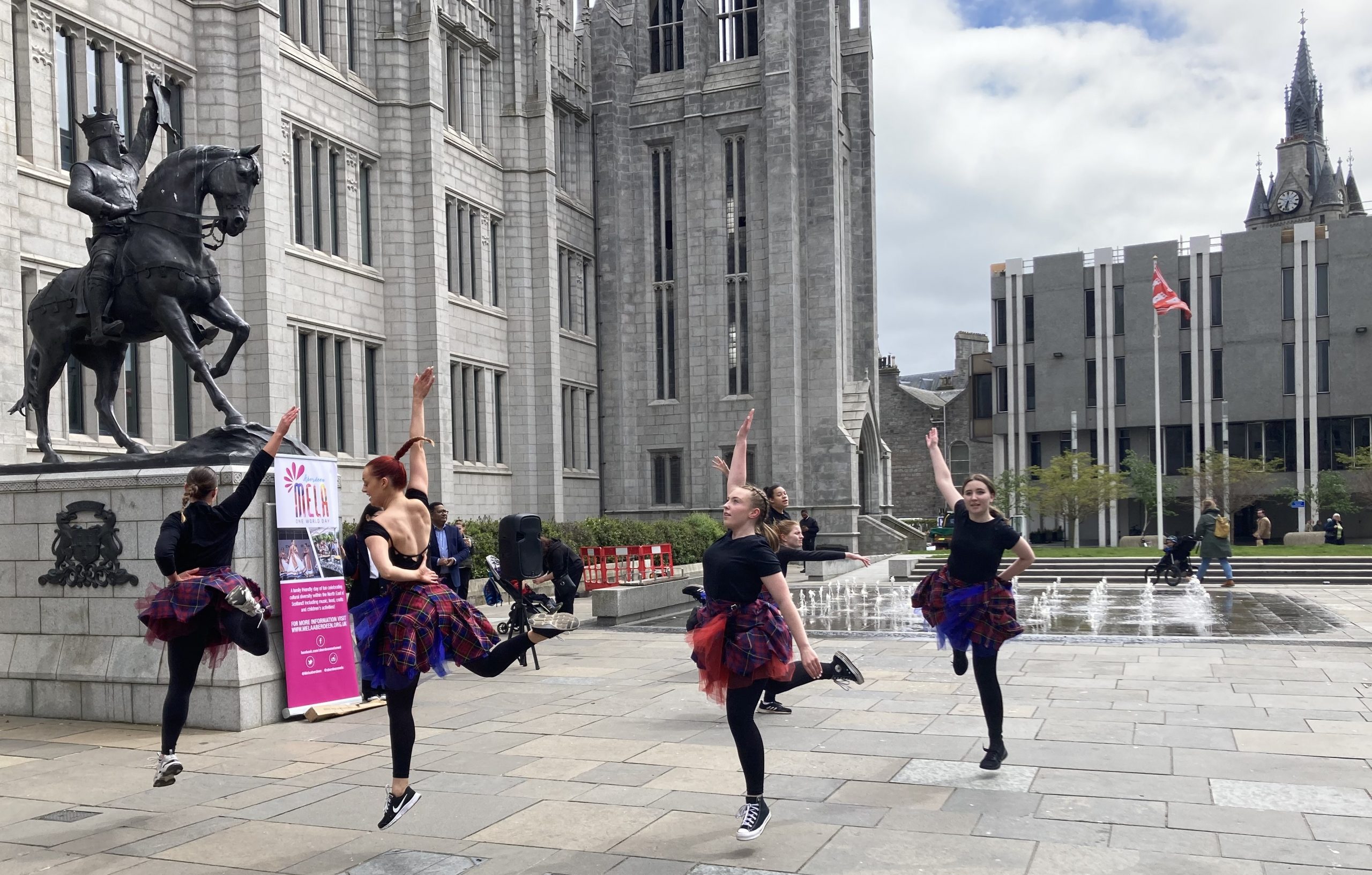 Citymoves dancers dancing outdoors with a fountain in the background. Photo courtesy of Jay Jay Oz.