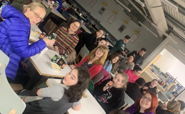 People sat around tables with snacks.