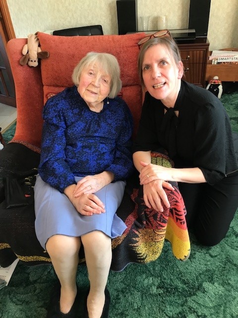 Aileen Gourlay from Dundee sitting in a chair and NESS's Gill Sutherland crouching beside her.