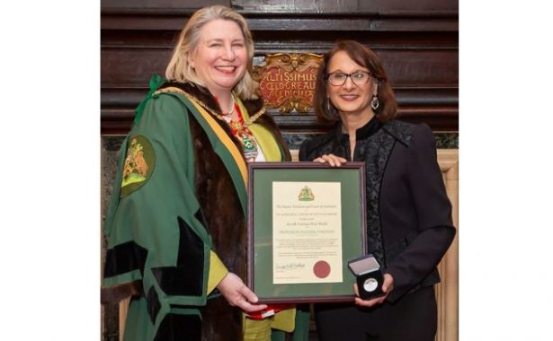 Photograph shows the Master presenting Professor Pardhan with her citation and silver medal at Apothecaries' Hall. Copyright of Worshipful Company of Spectacle Makers / Mark Witter Photography.