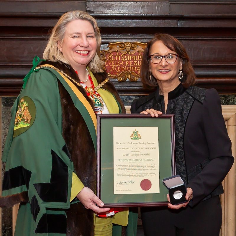 Photograph shows the Master presenting Professor Pardhan with her citation and silver medal at Apothecaries' Hall. Copyright of Worshipful Company of Spectacle Makers / Mark Witter Photography.