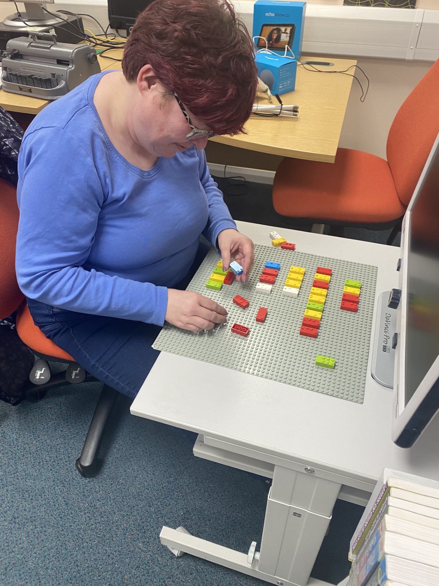 Morag sat a table with Braille Lego.