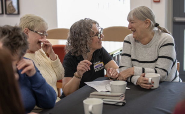 Sense Ability Matters staff member Helen Mullen with participants at a Sense Ability Matters social group