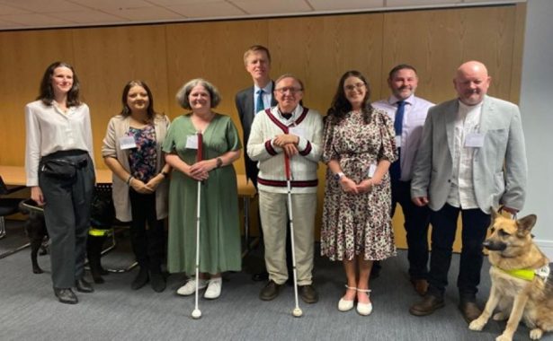 Seven representatives from the Vision Partnership charities standing in a meeting room inside the Department for Work and Pensions with Sir Stephen Timms, Minister for Social Security and Disability in the centre of the group on 19 May 2025.,