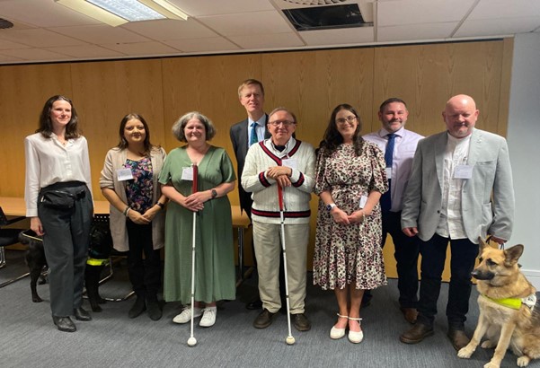 Seven representatives from the Vision Partnership charities standing in a meeting room inside the Department for Work and Pensions with Sir Stephen Timms, Minister for Social Security and Disability in the centre of the group on 19 May 2025.,