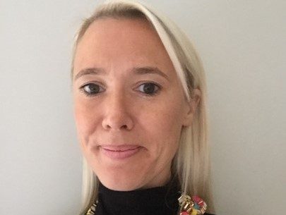 A head and shoulders image of Charlotte, who has long blond hair, pushed back behind her shoulders. Charlotte is wearing a black top with a colourful beaded necklace. A head and shoulders image of Charlotte, who has long blond hair, pushed back behind her shoulders. Charlotte is wearing a black top with a colourful beaded necklace.