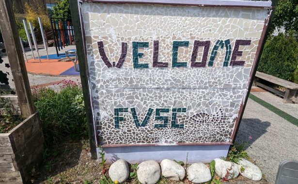 Large, square, tactile, mosaic sign in garden says "Welcome FVSC".