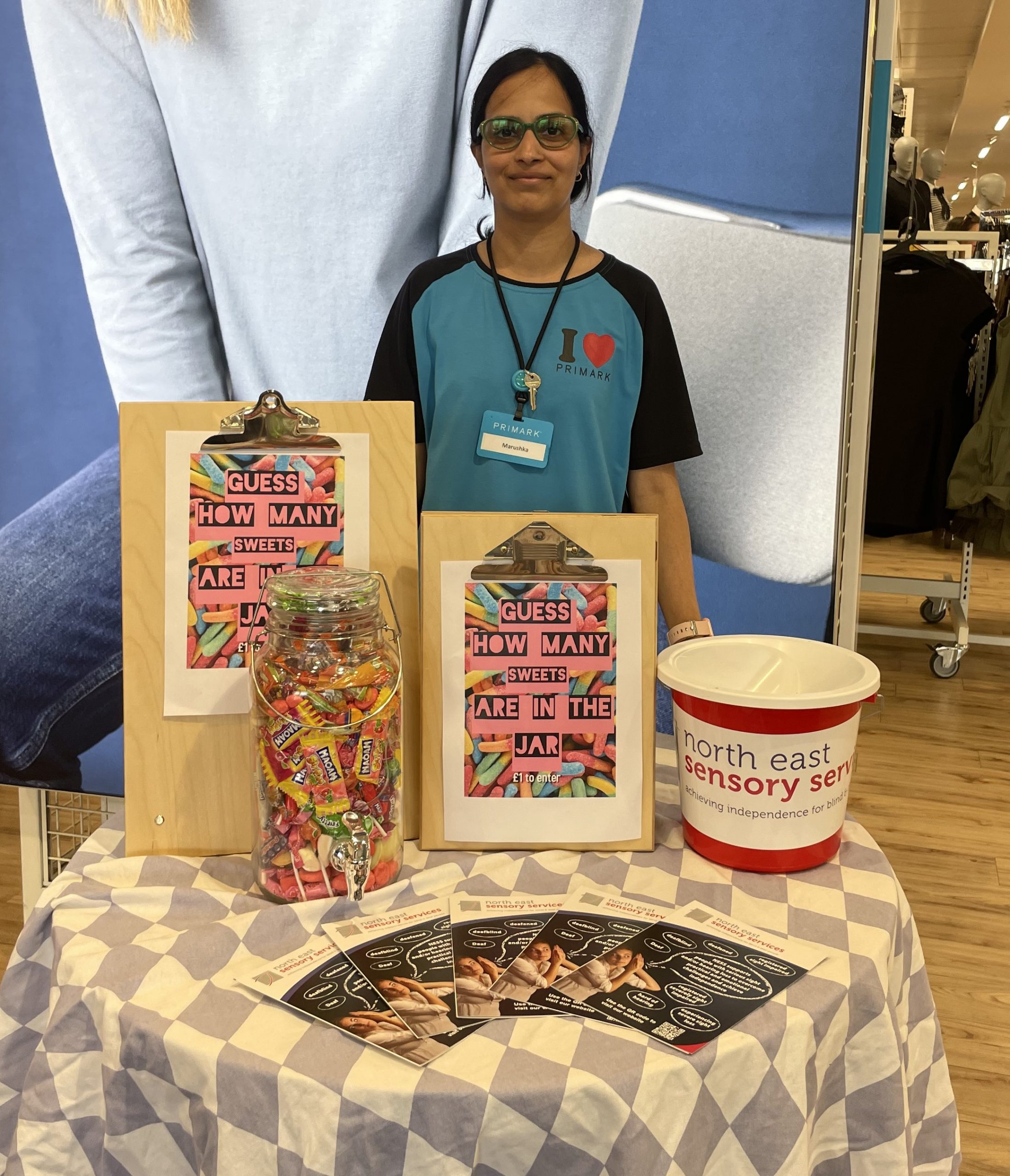 Primark Aberdeen Union Street team member standing in store behind a table, fundraising for NESS.