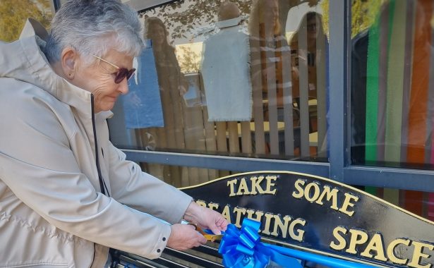 Maureen Smith cuts the ribbon on the Breathing Space bench.