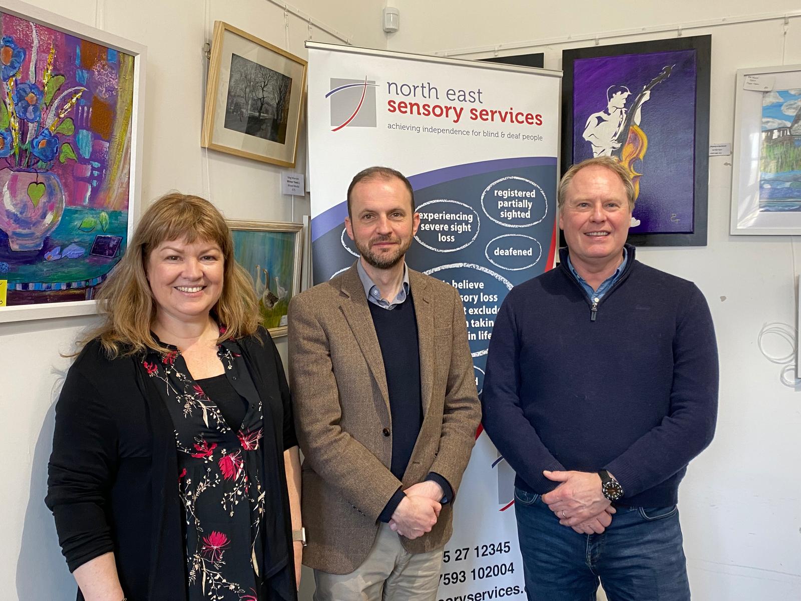 Left to right: NESS training and information officer Libby Hillhouse, Stephen Gethins MP and Ness chief executive Alan Bell, in front of a NESS information board.