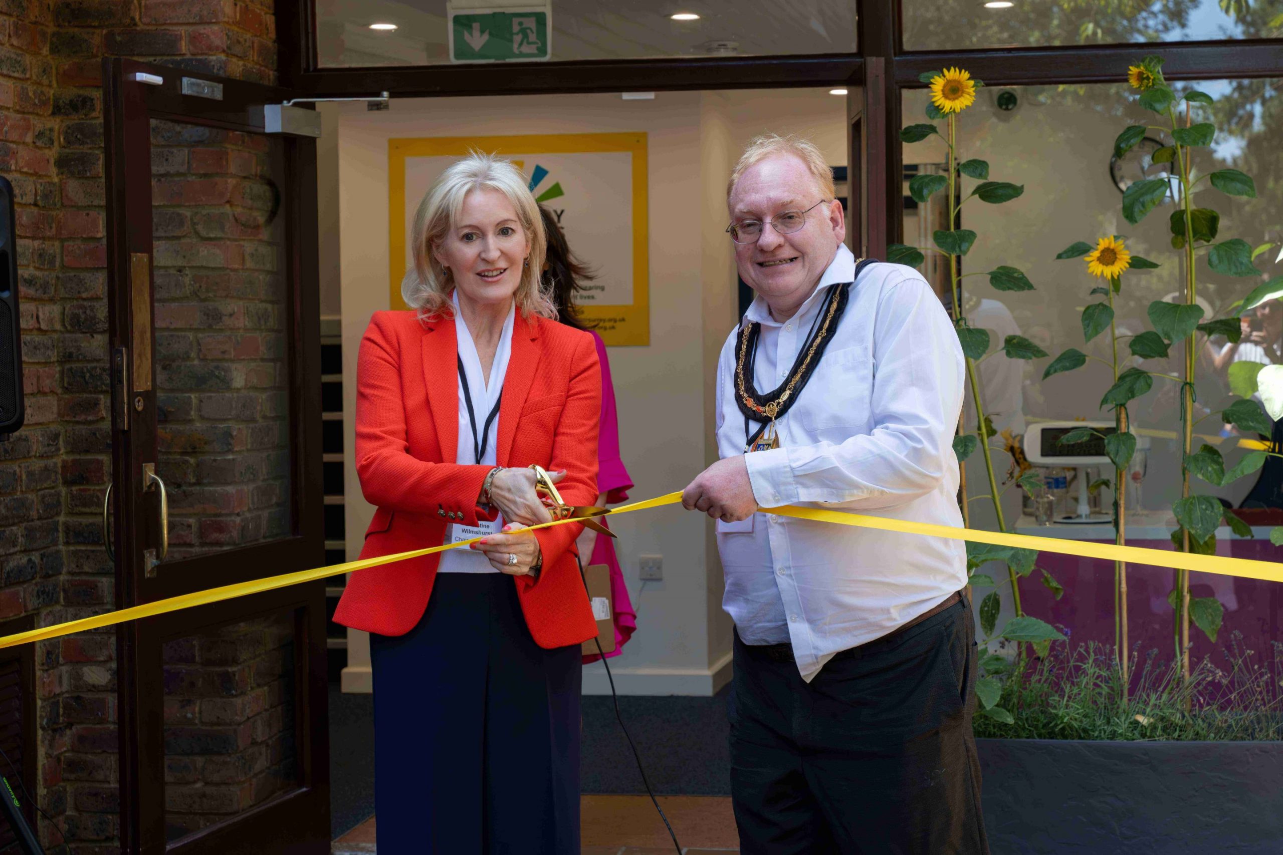 Picture credit: Calvin Cheung. Christine Wilmshurst and Tim Hall cutting ribbon.