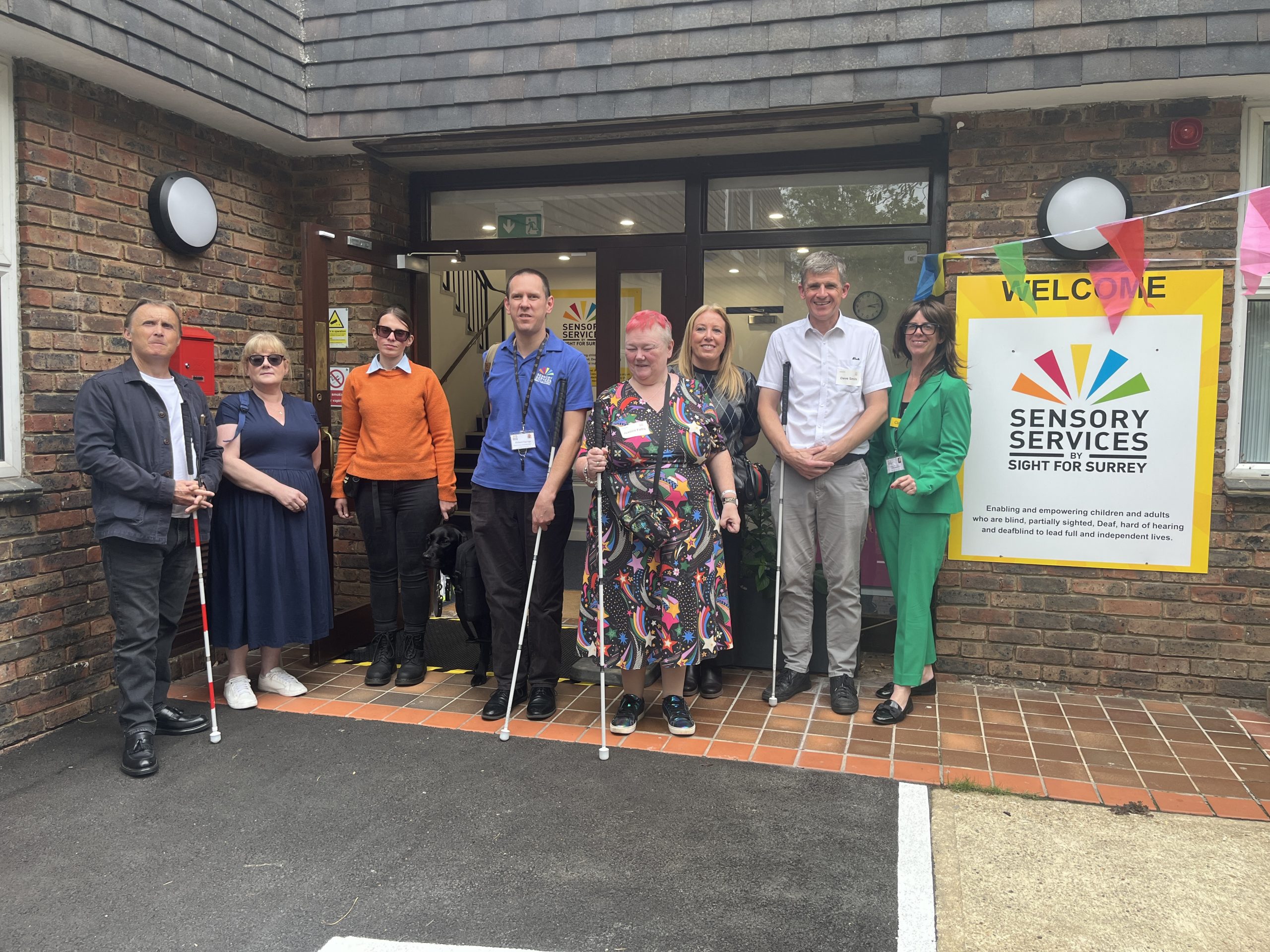 Volunteers and staff celebrate the launch of Surrey Sight Loss Council outside Sensory Services by Sight for Surrey in Redhill.